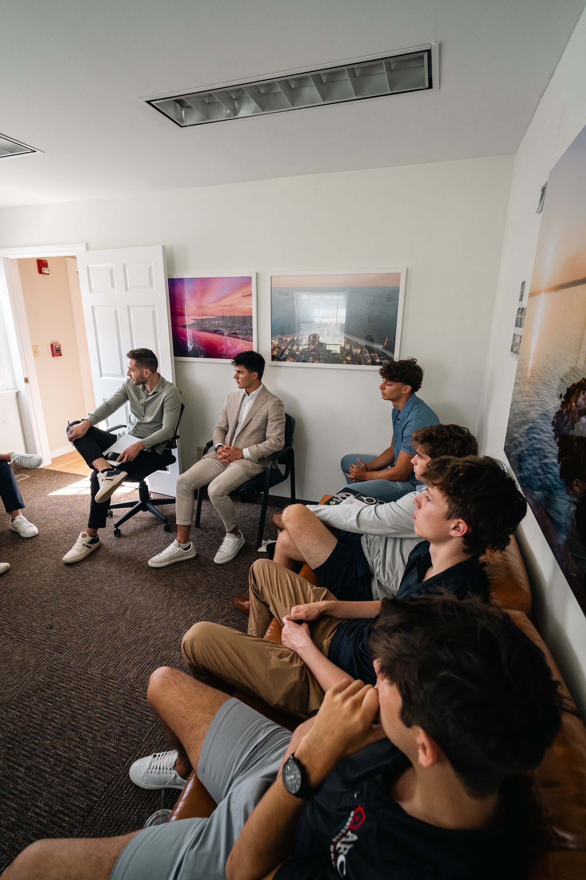 Wide view of the whole AFC team gathered in the office for the huddle