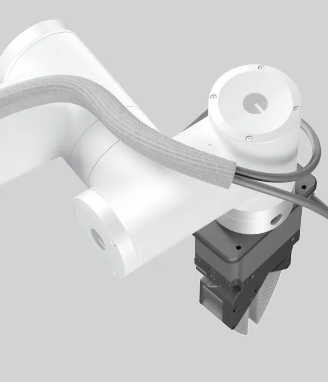 Close-up of a robotic arm with a black end effector featuring multiple white suction cups.