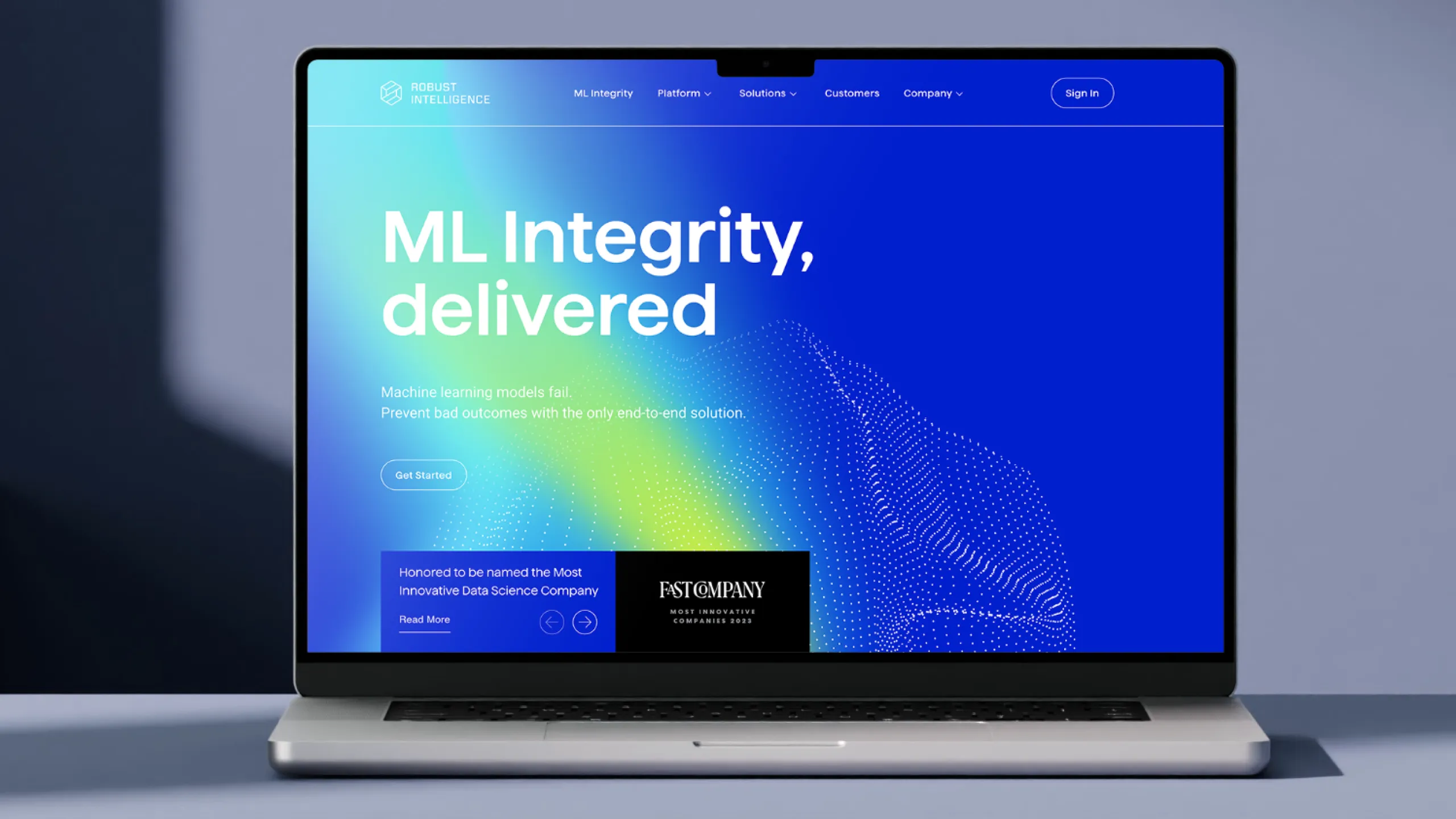Robust Intelligence website on a laptop, with the headline "ML Integrity, delivered" over a blue gradient