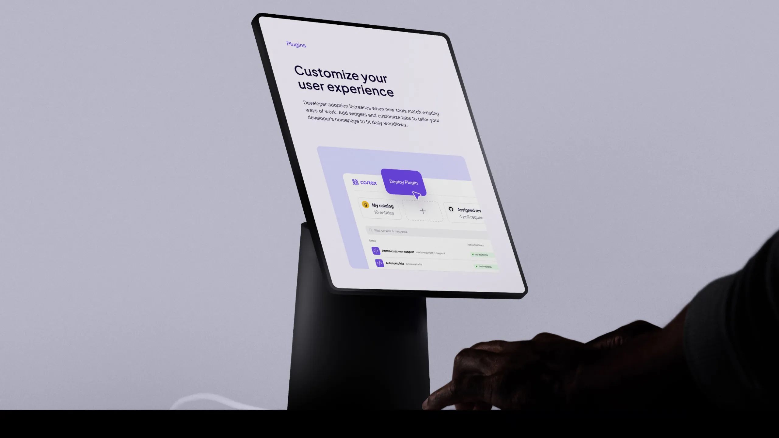 Cortex website on a tablet mounted on a stand, showing the "Customize your user experience" plugins page