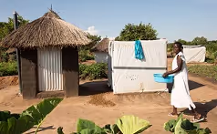 Diana Ija, mother of five and wife to Robert Khemis moves to use the facility. Photo by James Kiyimba / JMC Uganda