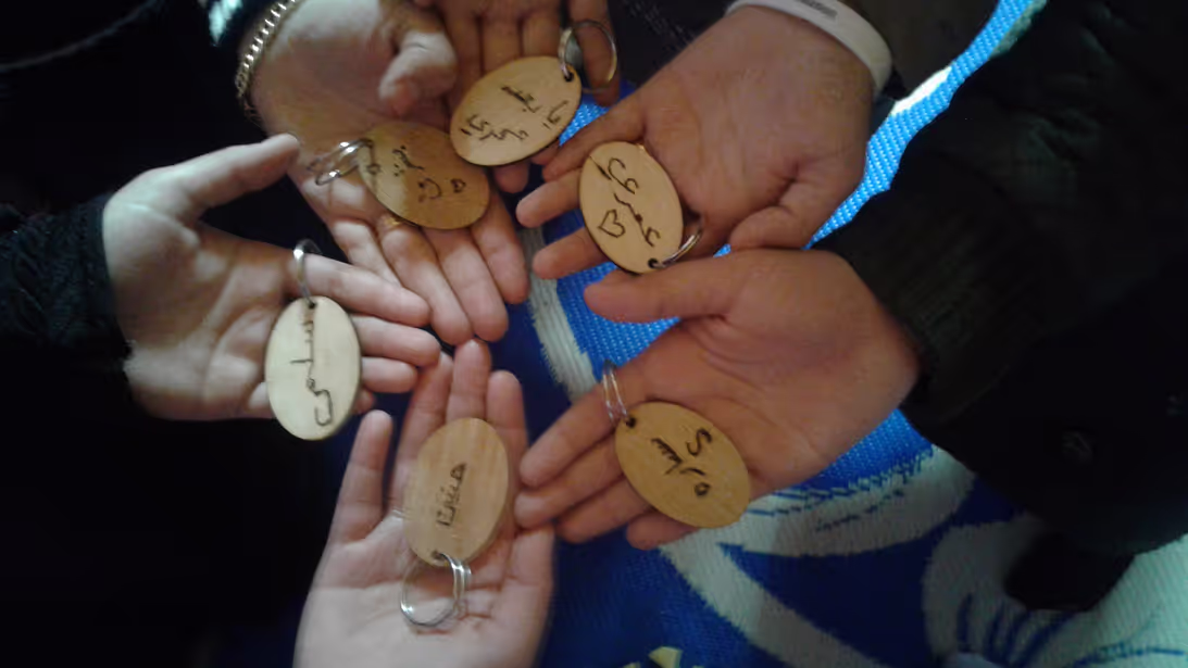 Participants showing keychains made as a curriculum-end souvenir (Credit: IRC)
