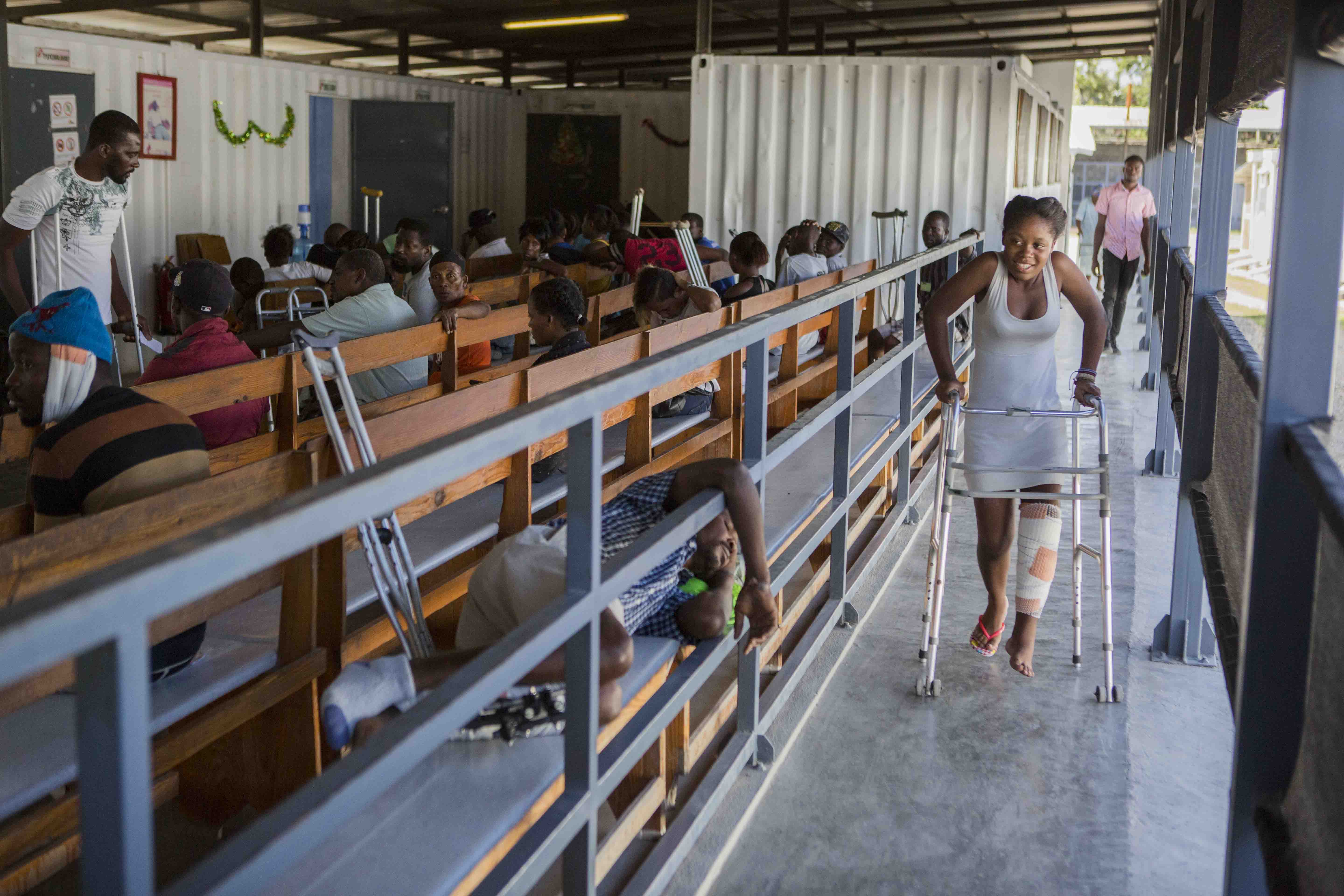 Cheldine Jean Pierre, 17, leaving the clinic at Nap Kenbe Hospital after being treated of a gunshot wound in her left foot after being shot by her best friend's boyfriend. Credit: Jeanty Junior Augustin/MSF