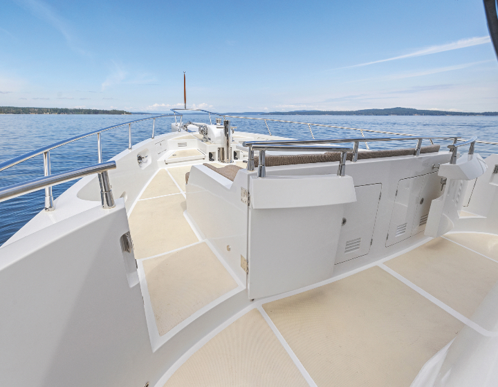 boat deck overlooking calm blue water and shore