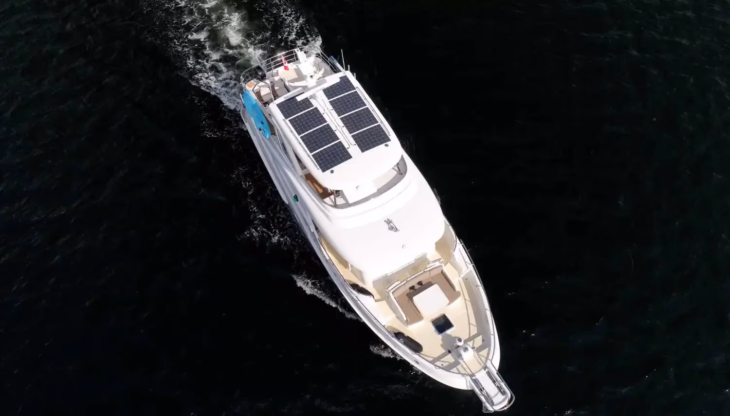 Yacht sailing tips include utilizing solar panels for energy efficiency, as seen on this luxurious yacht navigating dark open waters.