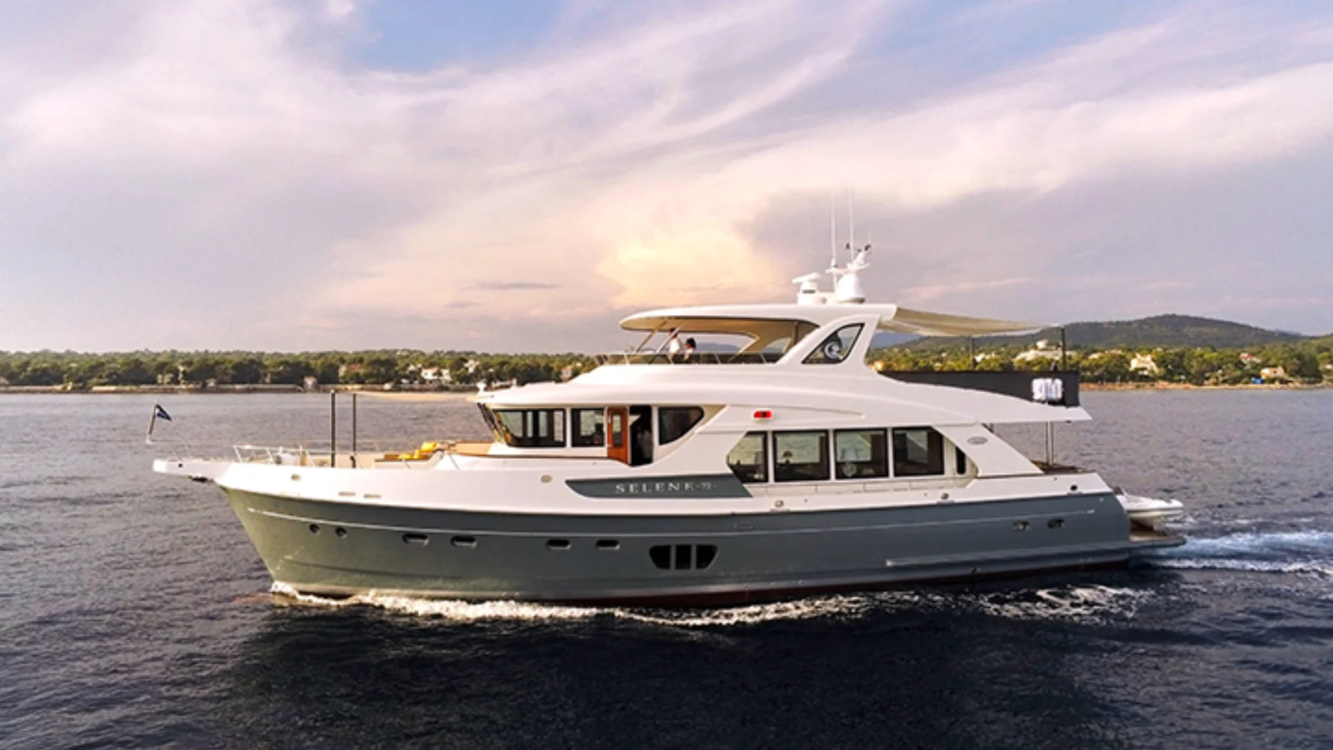 72 ocean luxury yacht cruising under partly cloudy sky