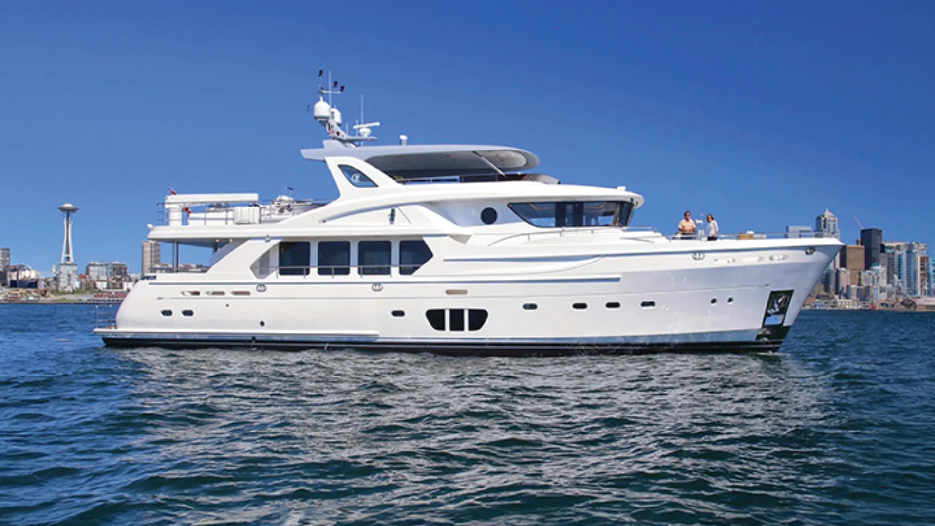 92 ocean explorer white yacht on water with city skyline backdrop