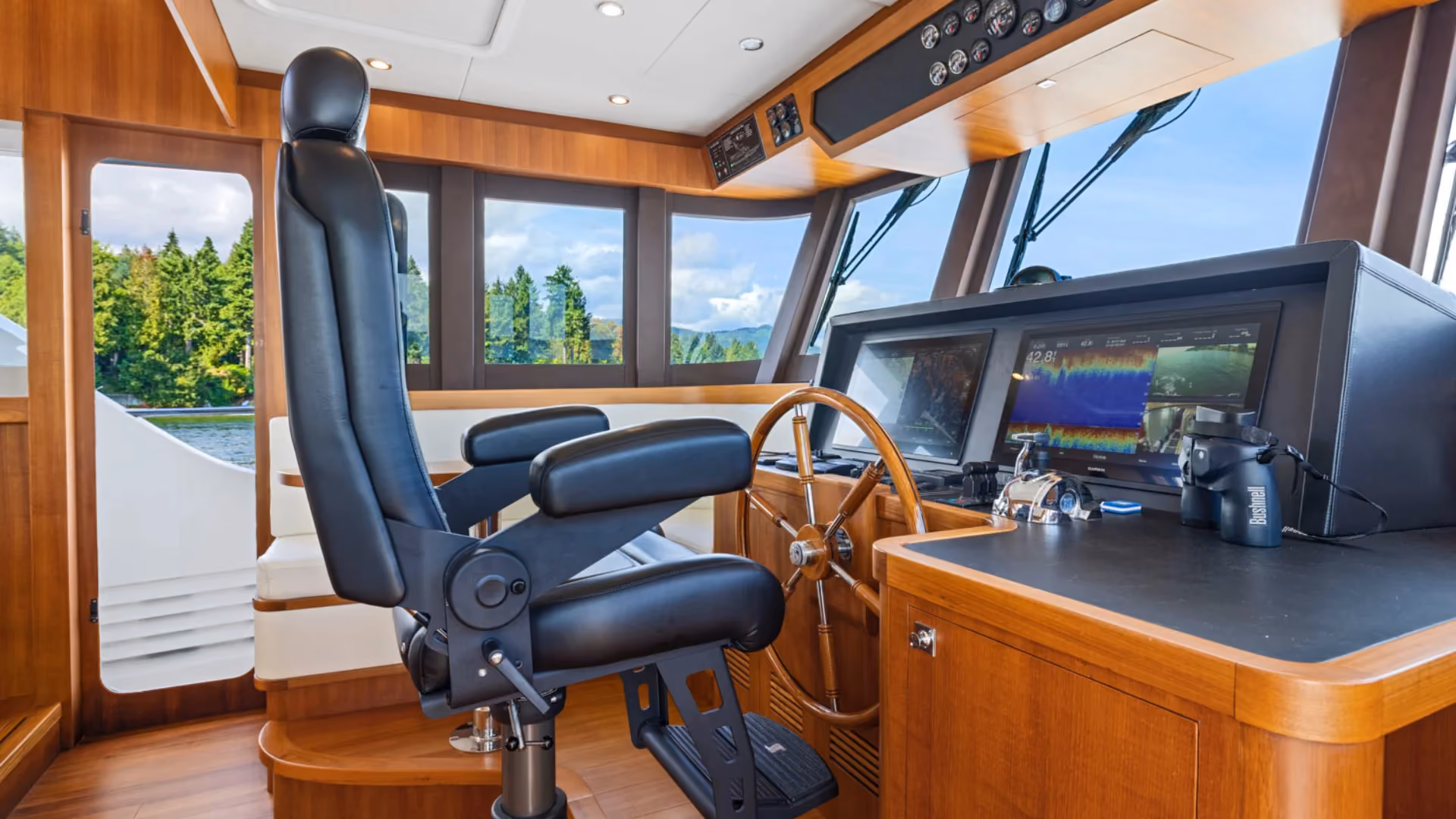 60 ocean boat steering cabin with control screens and chair