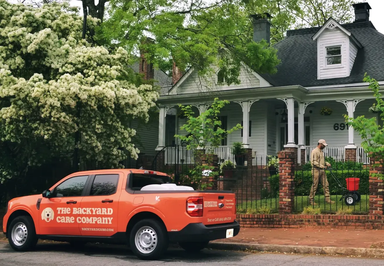 A lush green lawn with vibrant flowers and trees in the historic Marietta Square