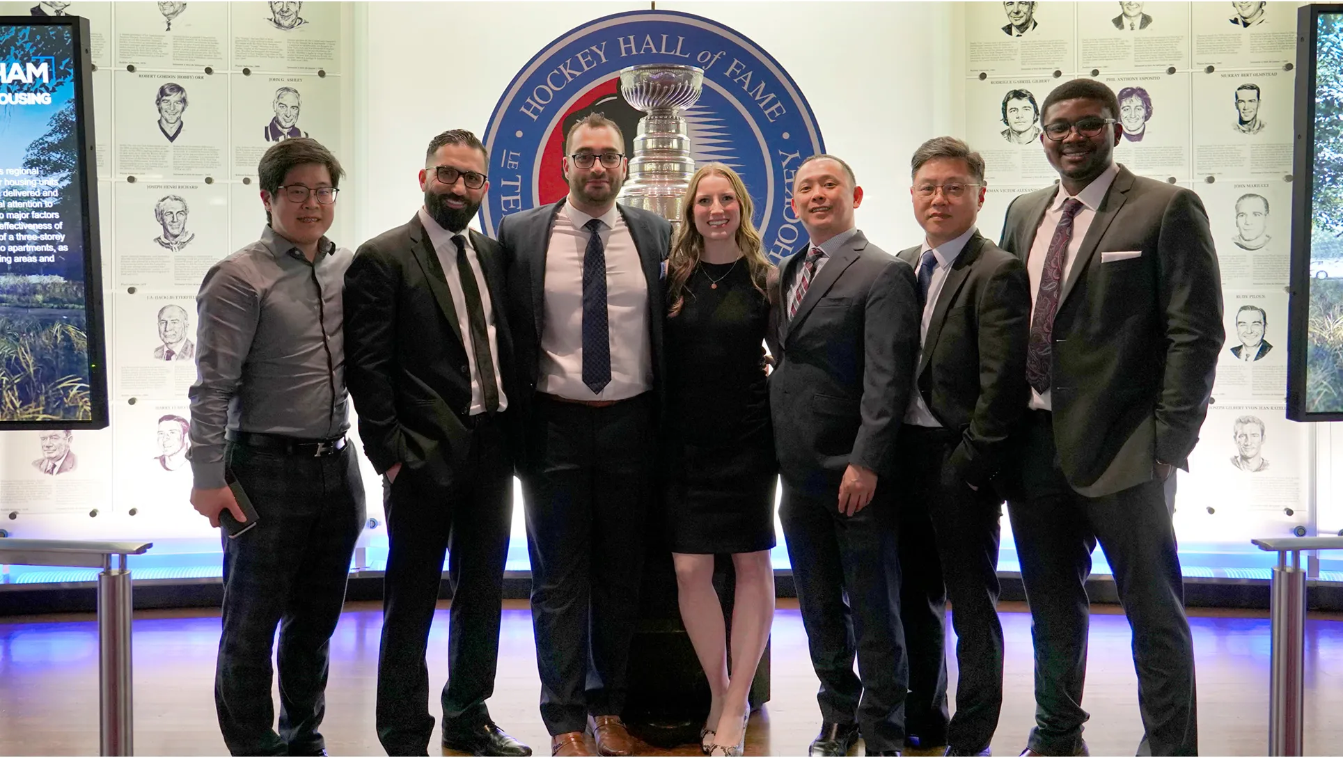 Group photo at Hockey Hall of Fame with Stanley Cup in background