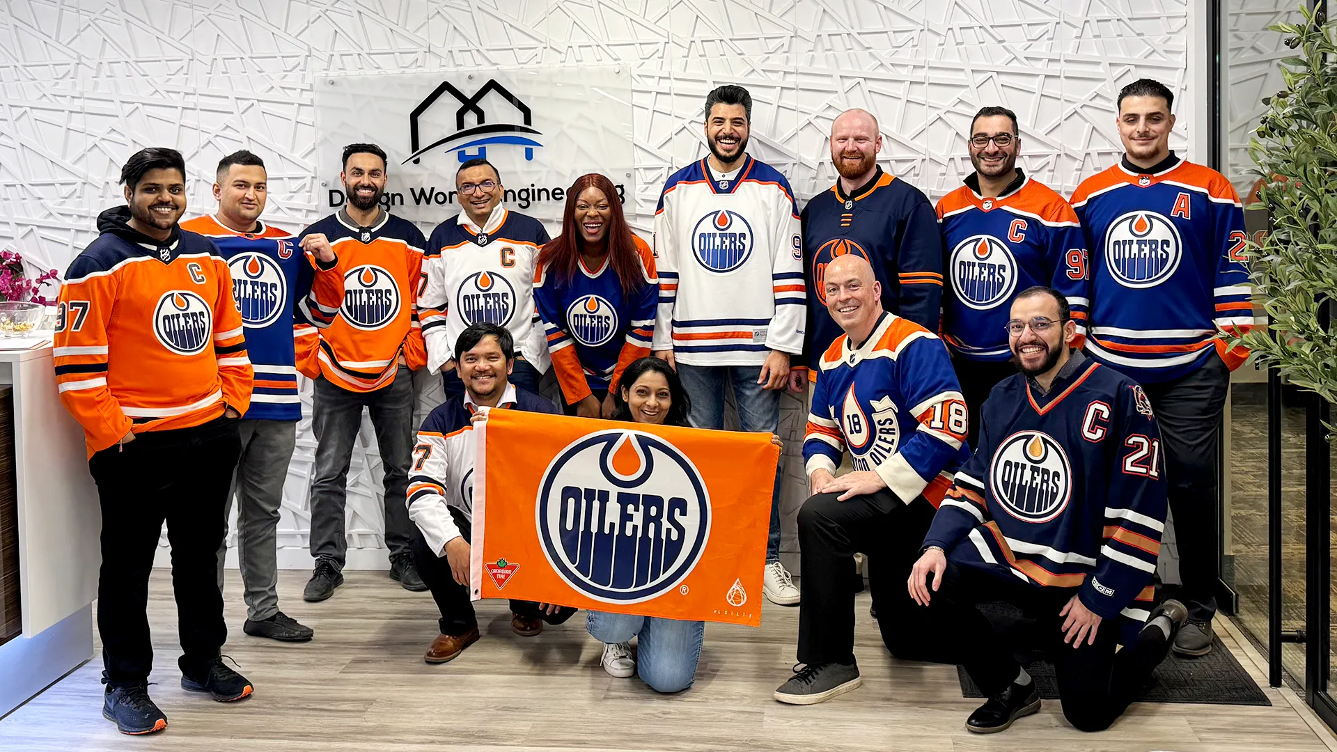 Team photo of employees wearing Edmonton Oilers hockey jerseys