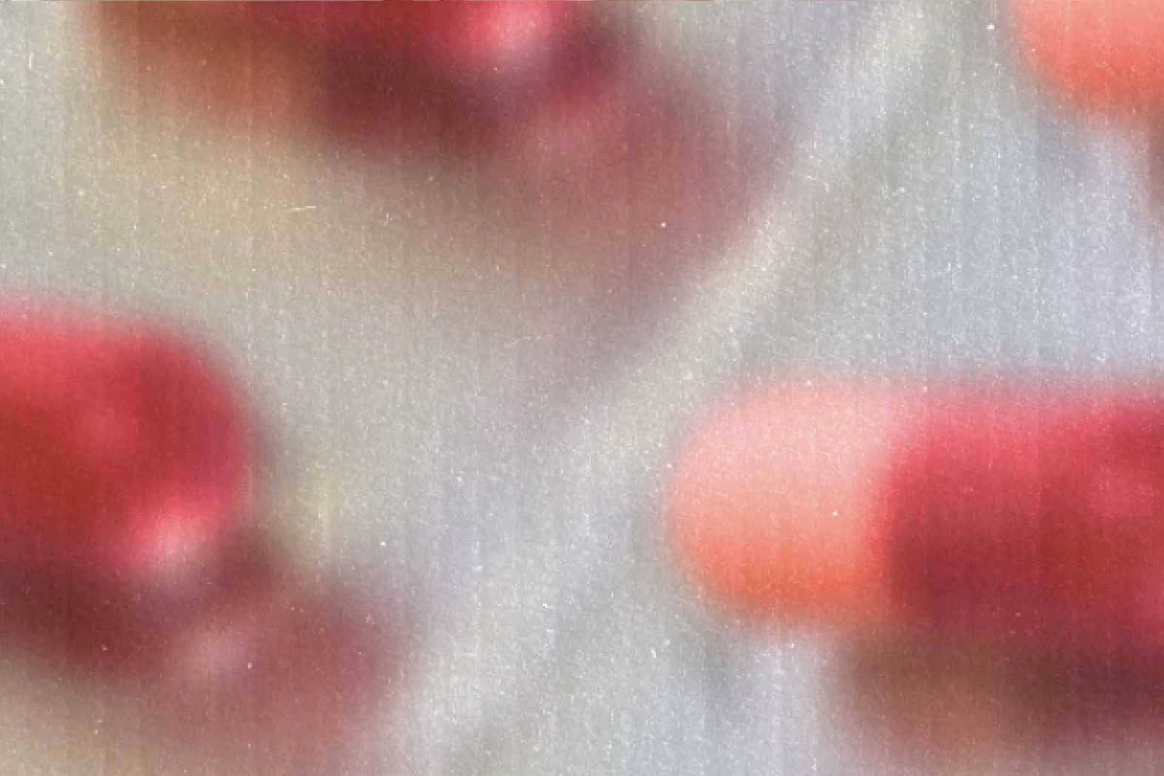 A zoomed-in shot of pink and red antibiotics for UTIs