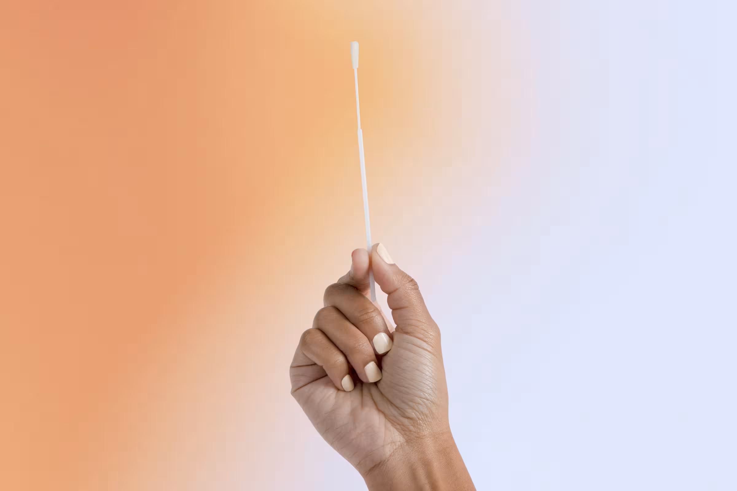 a macro shot of a woman holding a vaginal swab