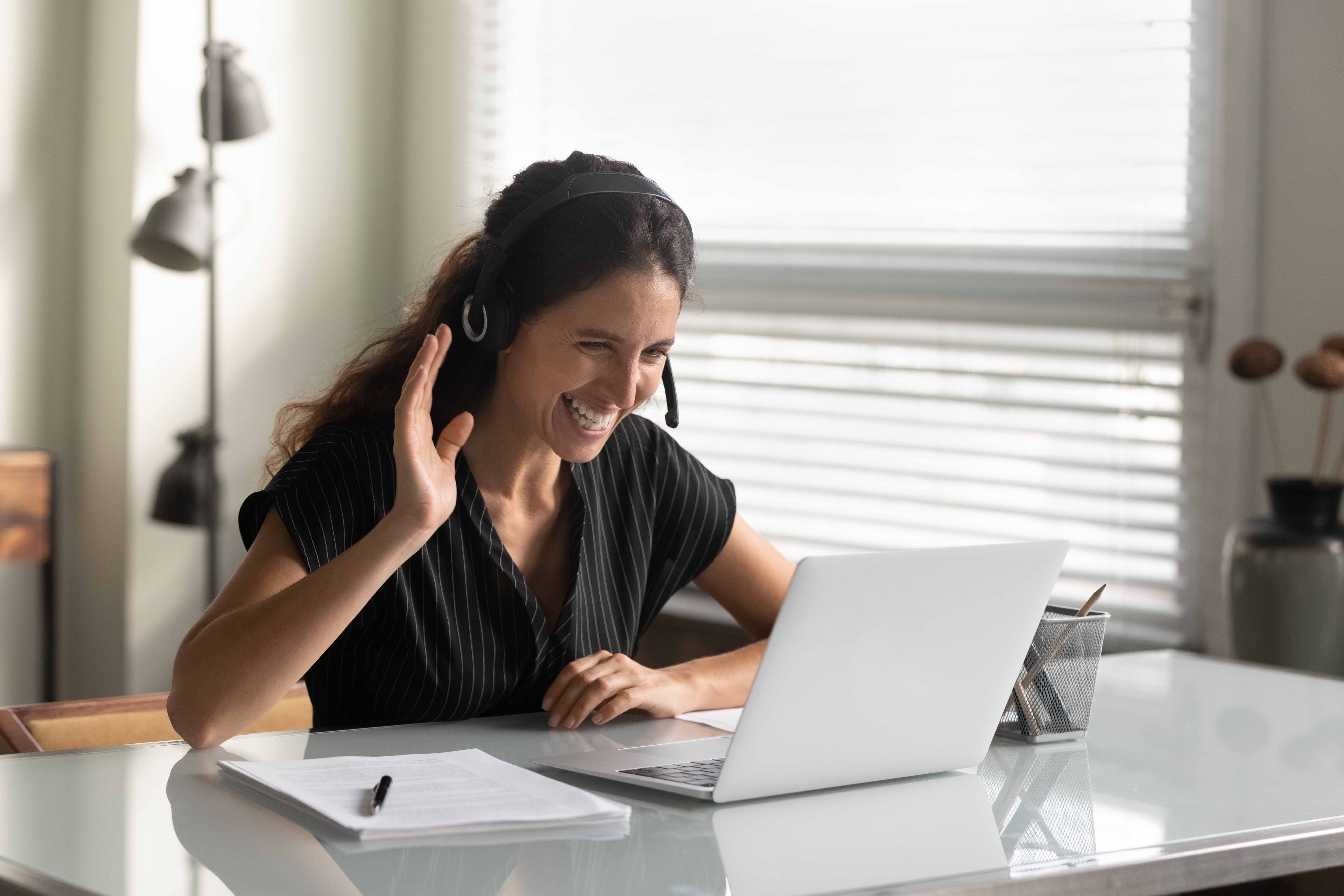 Smiling wellness practitioner on a video call with a client, showing how modern alternatives to EHR systems for hospitals support engaging, remote care.