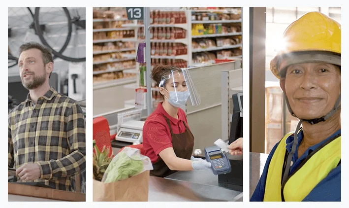 Man in plaid shirt, cashier with face shield and mask, and construction worker with yellow helmet smiling.