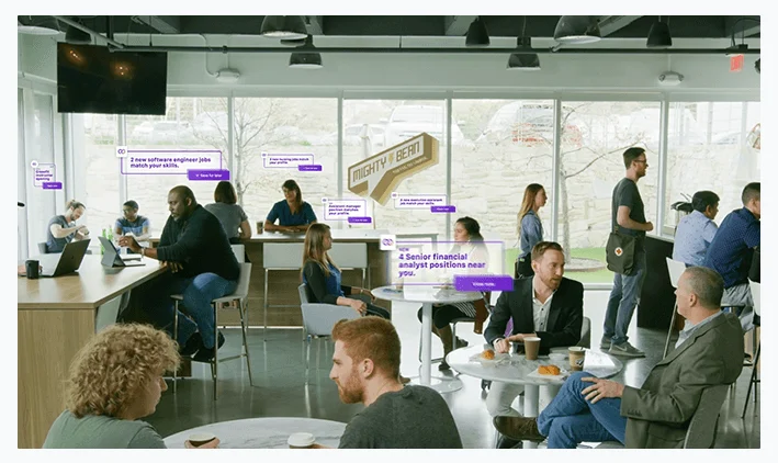 People working and talking in a modern cafe with job-related text overlays floating above.
