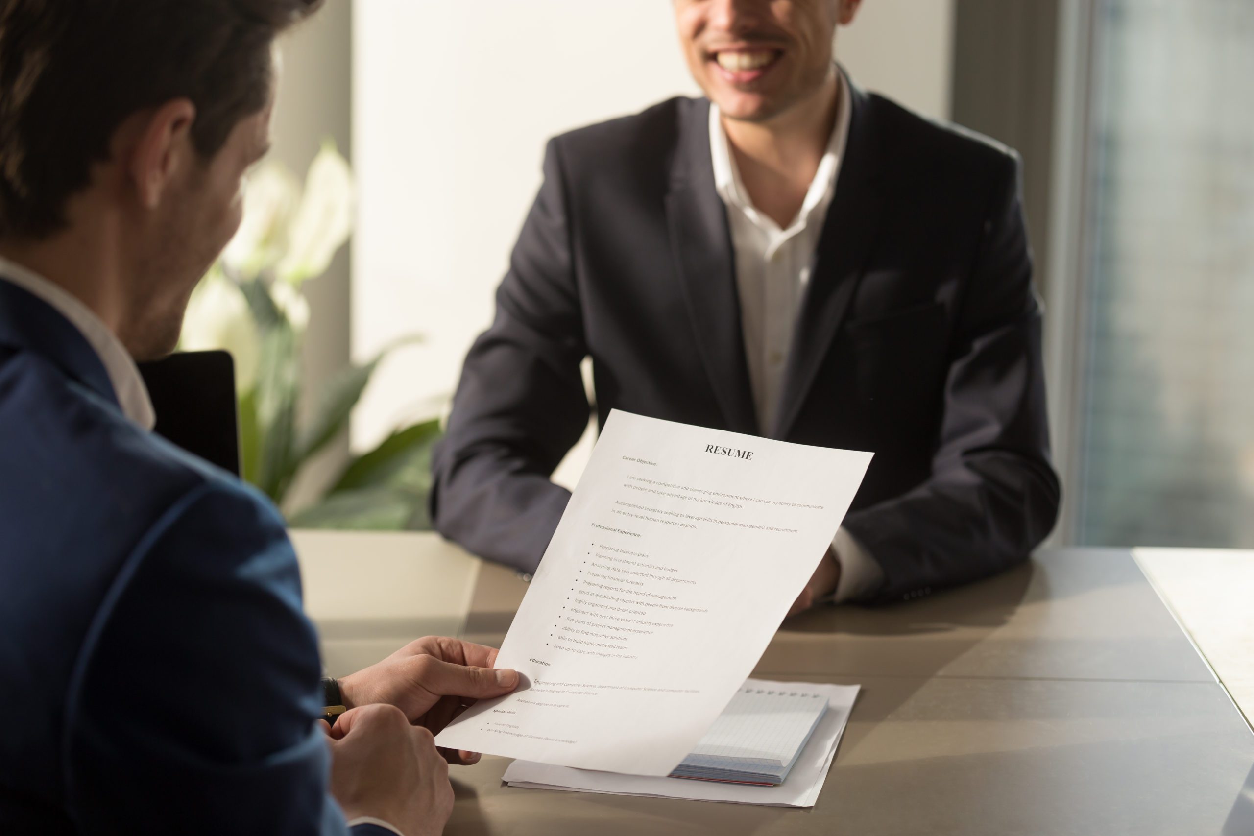 Person handing over a resume.