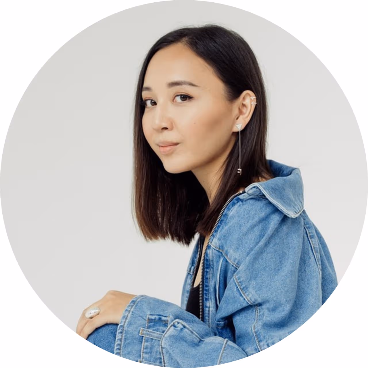 35mm shot profile photo of a young woman in blue jacket, kazakh with brown eyes and long hair, Leila Kaimoldanova