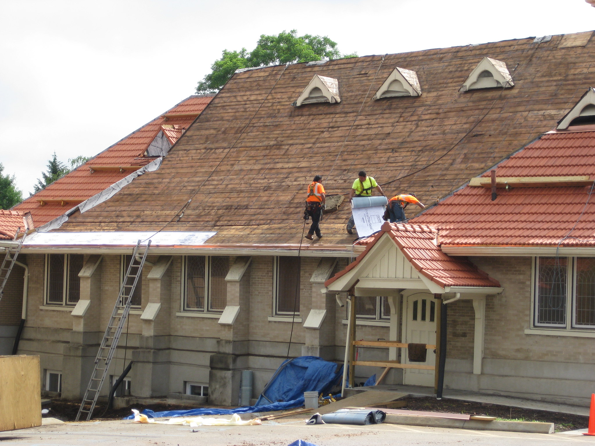 Workers install roof underlayment for a durable, weather-resistant foundation.