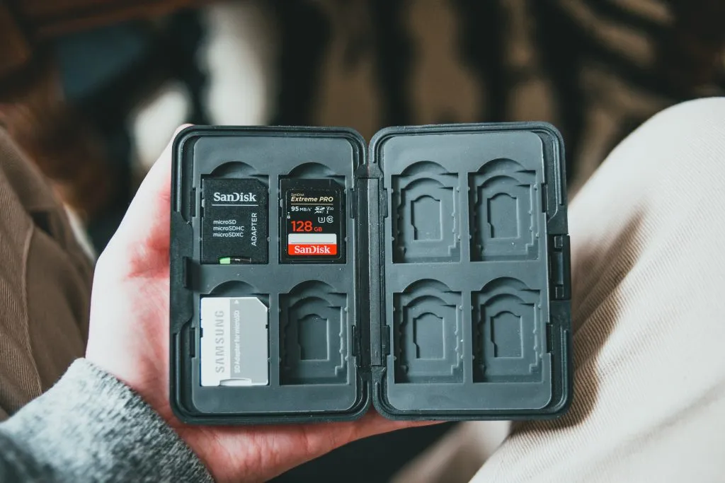 a man holding a small memory card case