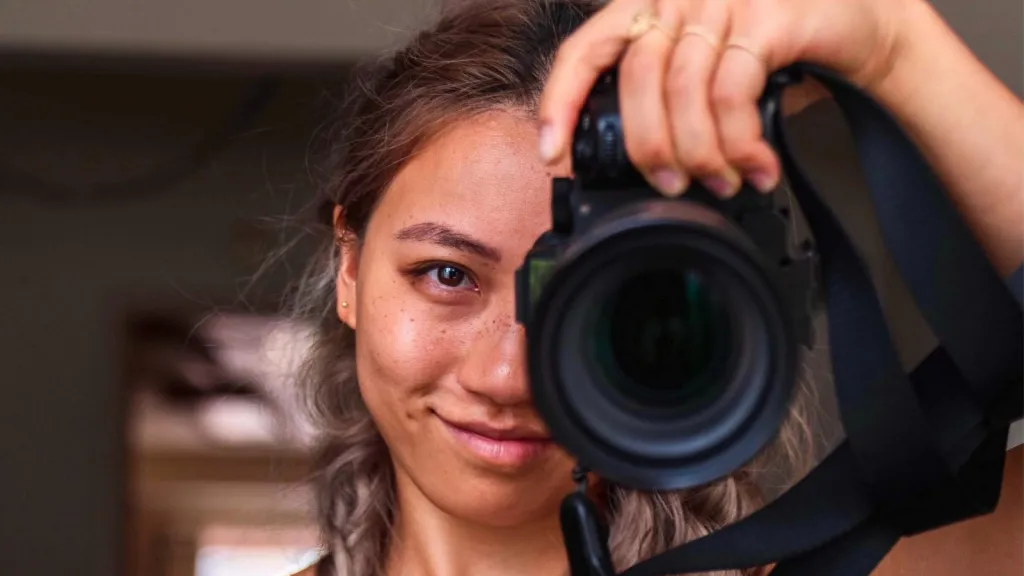 a girl taking a photo with a camera