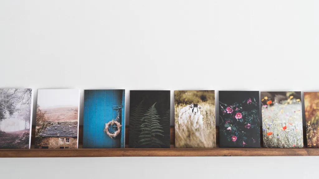 a bunch of postcards sitting on top of a shelf