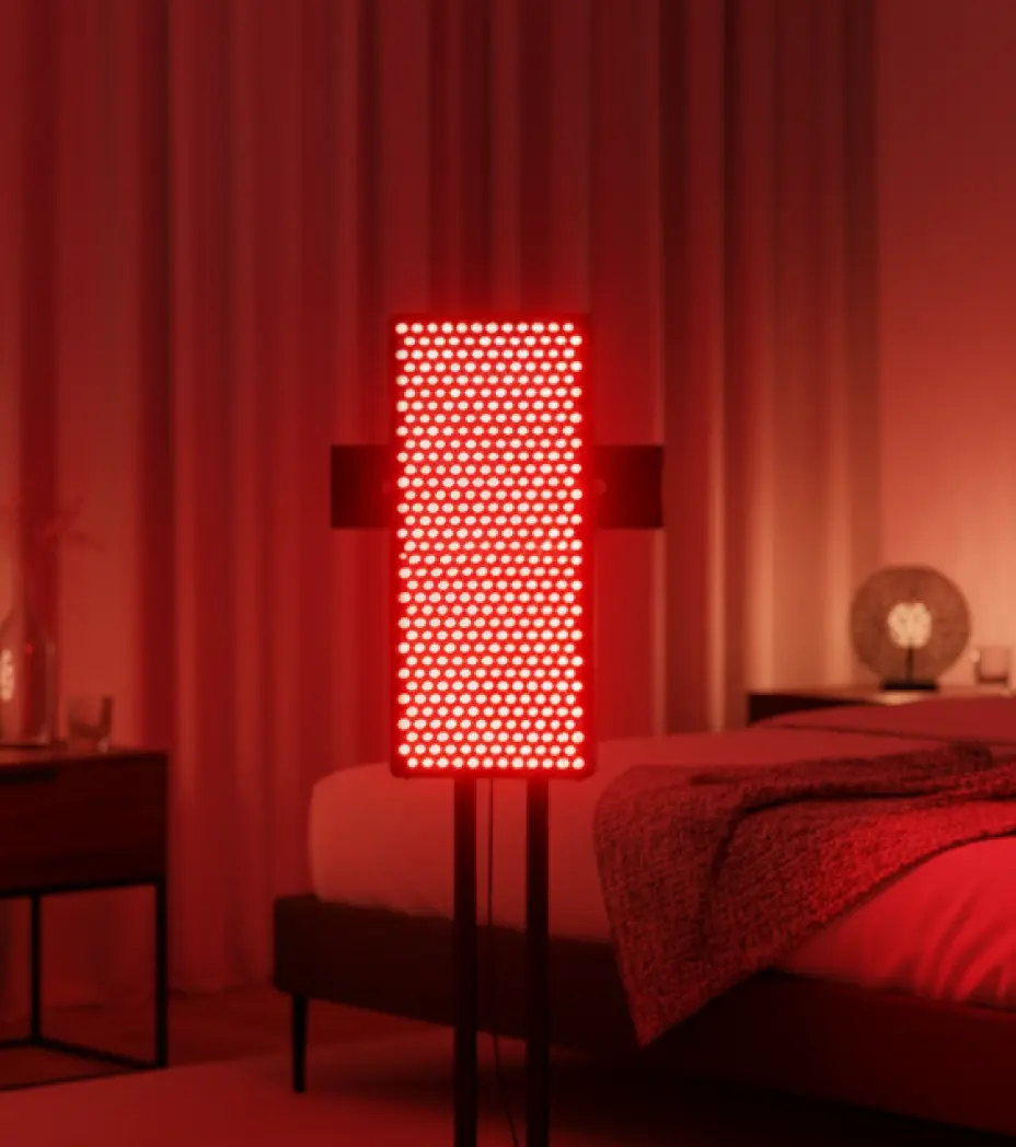 Red light therapy panel illuminating a bedroom interior