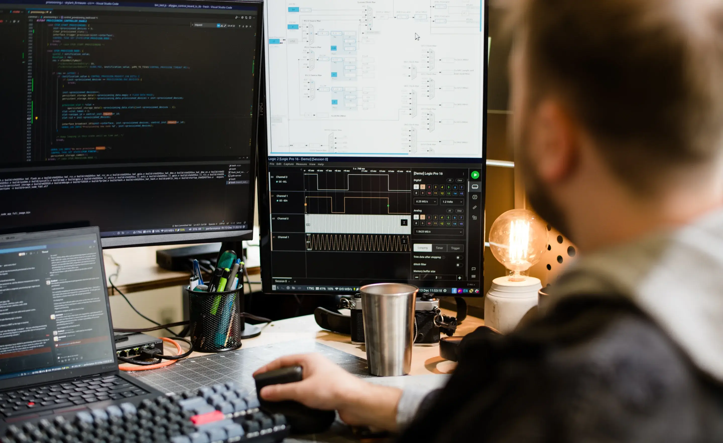 A man working on a computer with a large monitor.