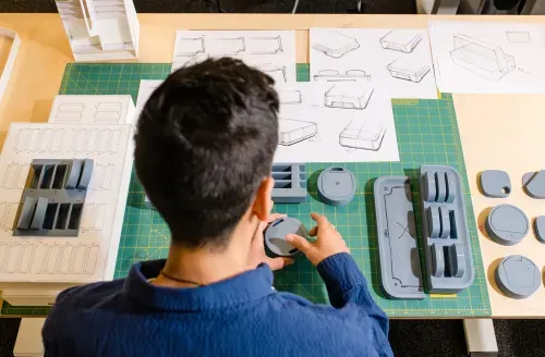 A man is working on a project at a table.