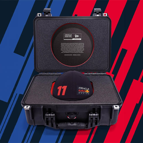 A Peli 1500 case open with black and red custom foam inserts created by MSA Foams for Red Bull Racing and New Era. A new Era cap sits in the base insert.