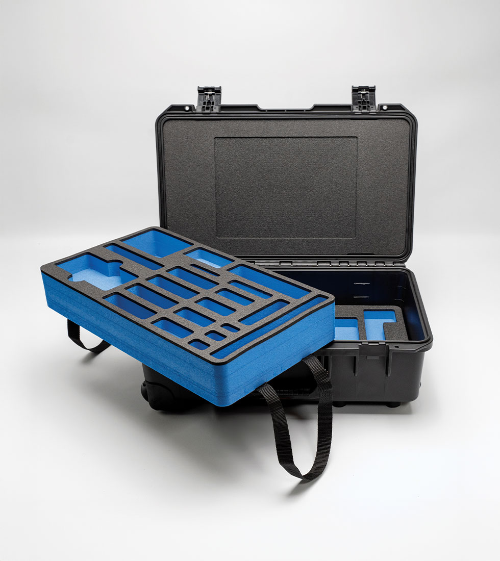 Black Peli Storm case with removable blue and black foam tray insert featuring precision-cut compartments