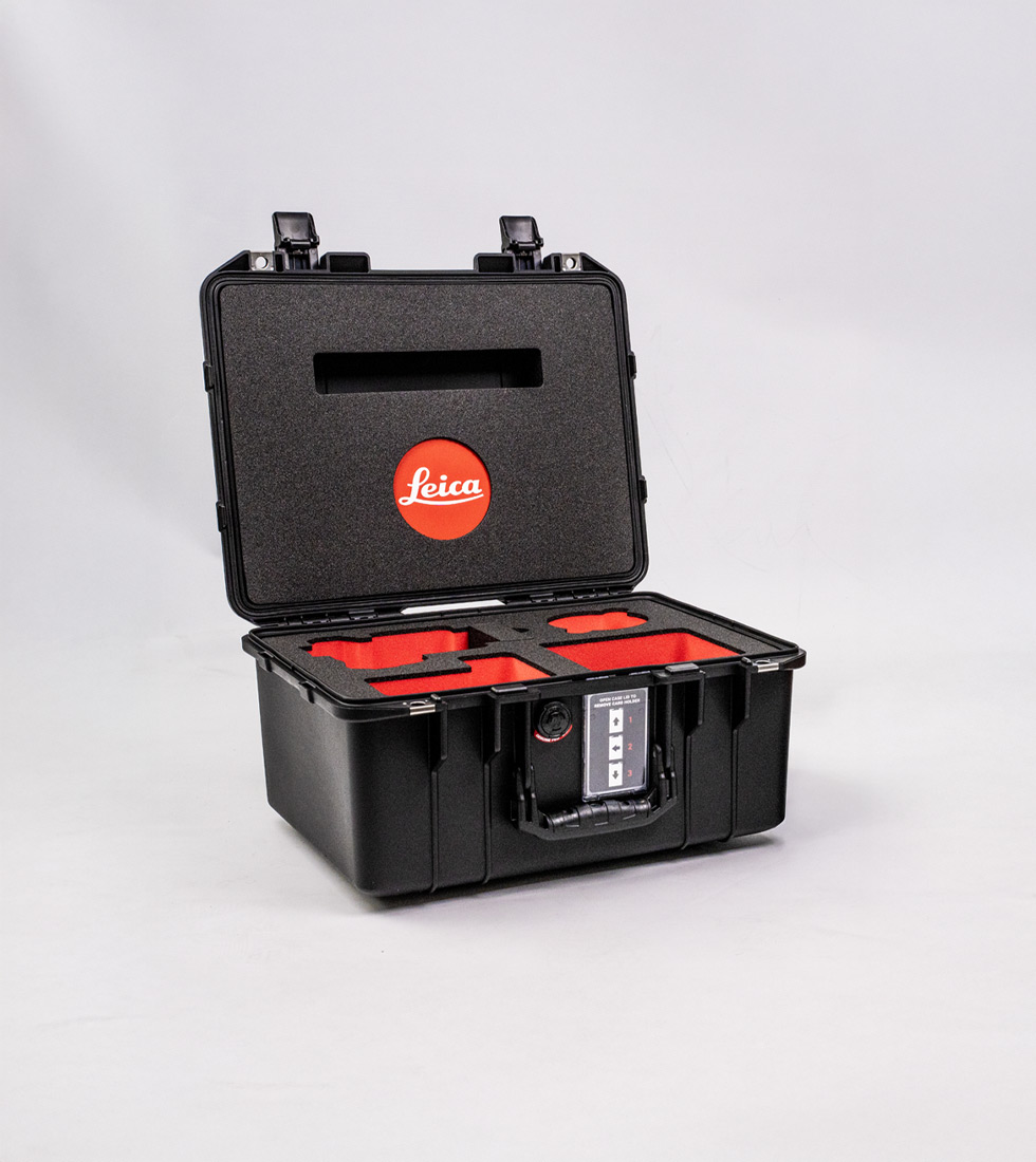 Custom Peli Air case with red and black foam insert and branded Leica lid cut-out for precision equipment transport