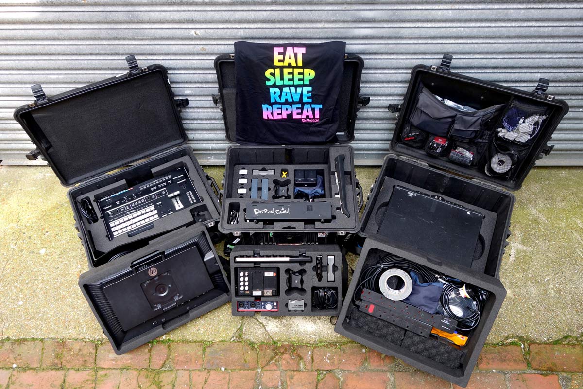 Custom foam inserts in multiple protective cases holding DJ and AV equipment for Fatboy Slim, including mixers, monitors, power leads, and accessories