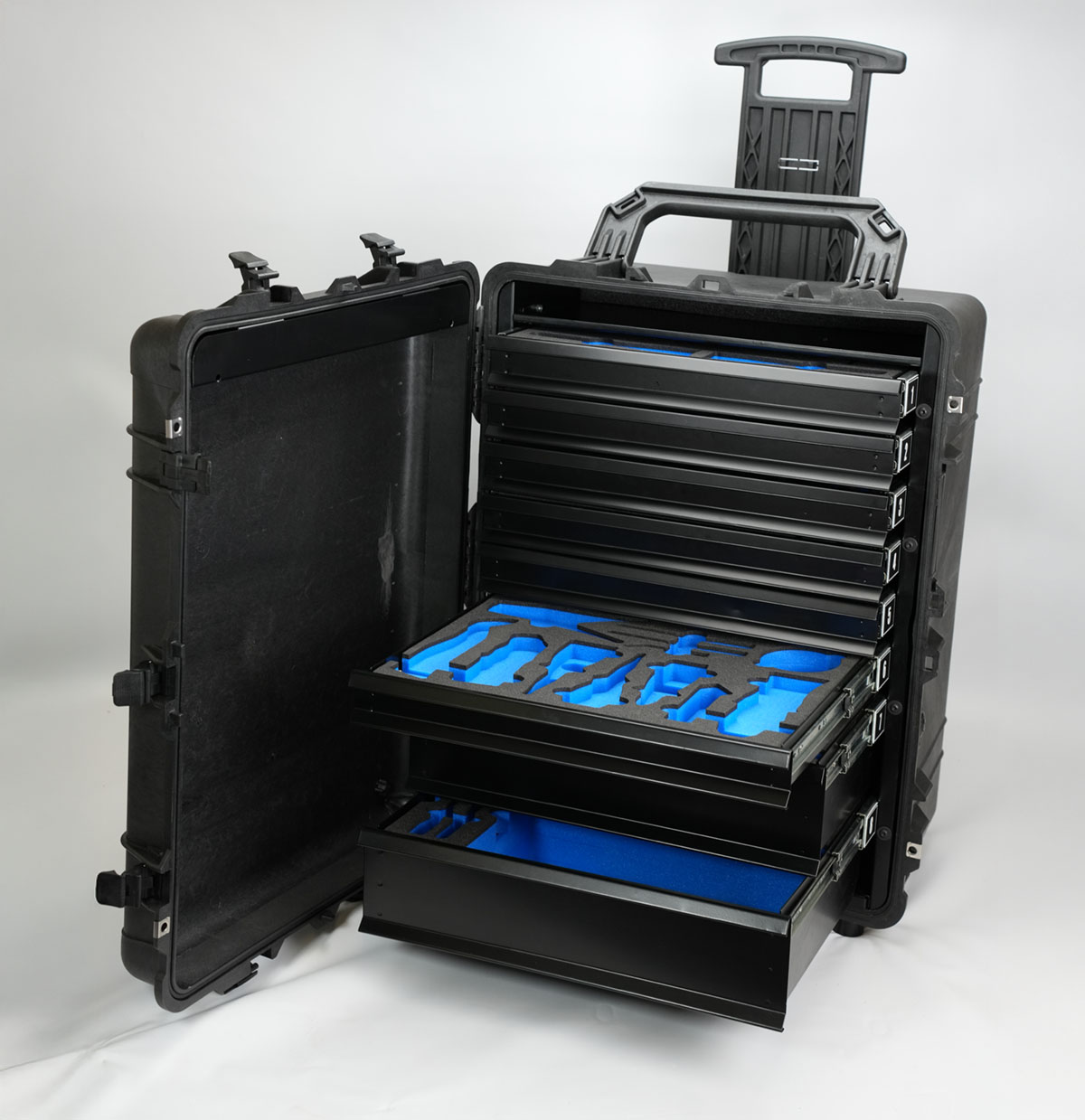 Custom Peli 1630 rolling case featuring custom drawer system with blue and black foam inserts for tool organisation and protection