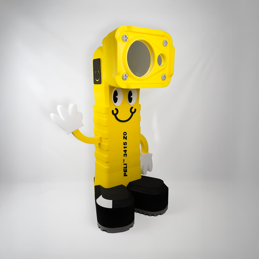 Custom foam character mascot designed to resemble the Peli 3415 Z0 torch, named Larry Lumen, with bright yellow body and friendly face