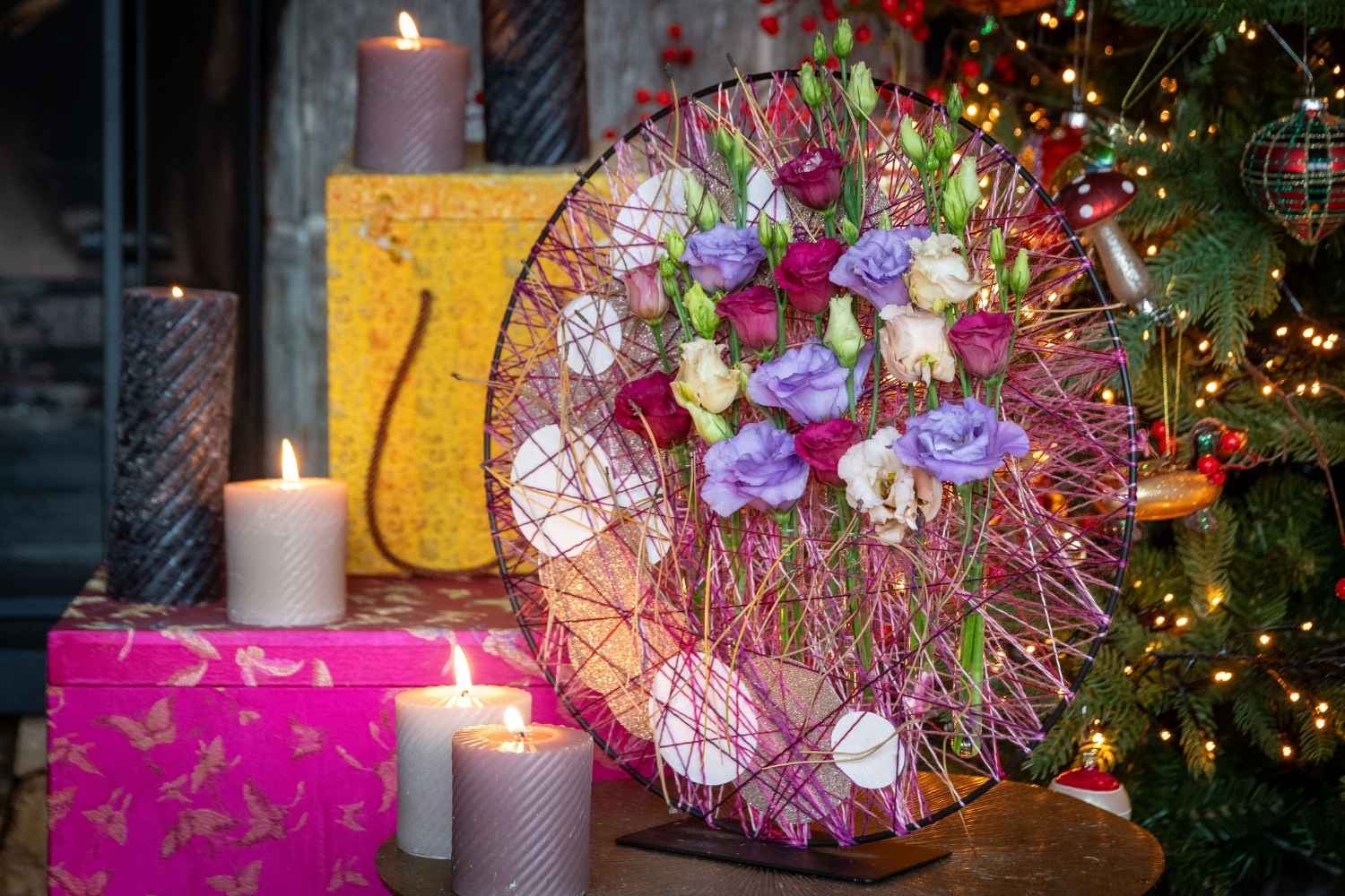 purple, pink, red, and white Lisianthus (Eustoma) blooms arranged in a circular string-art hoop, a creative Christmas decor idea.