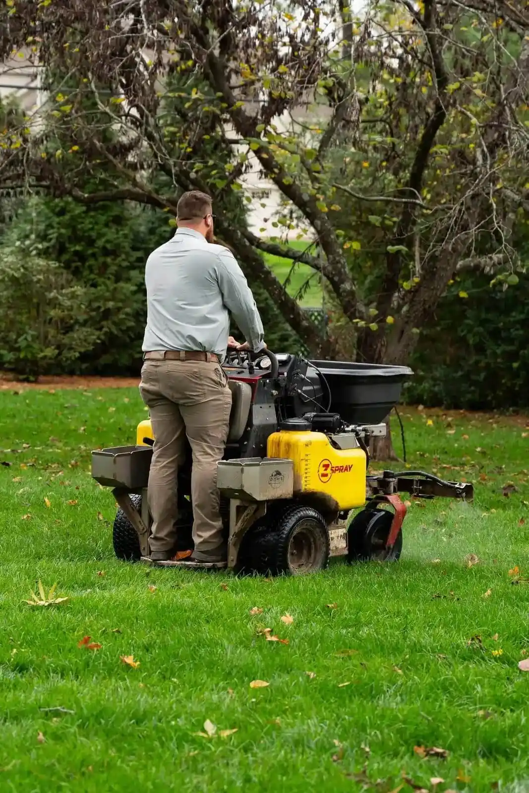Veragreen technician operating professional aeration equipment on residential lawn