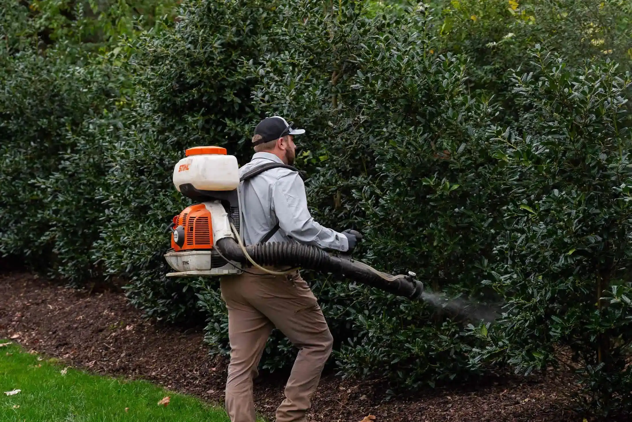 Veragreen technician using professional leaf blower equipment for landscape cleanup and maintenance