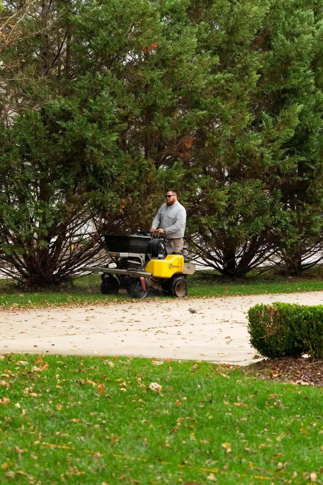 Veragreen service vehicle positioned at residential property with maintained lawn and mature landscaping
