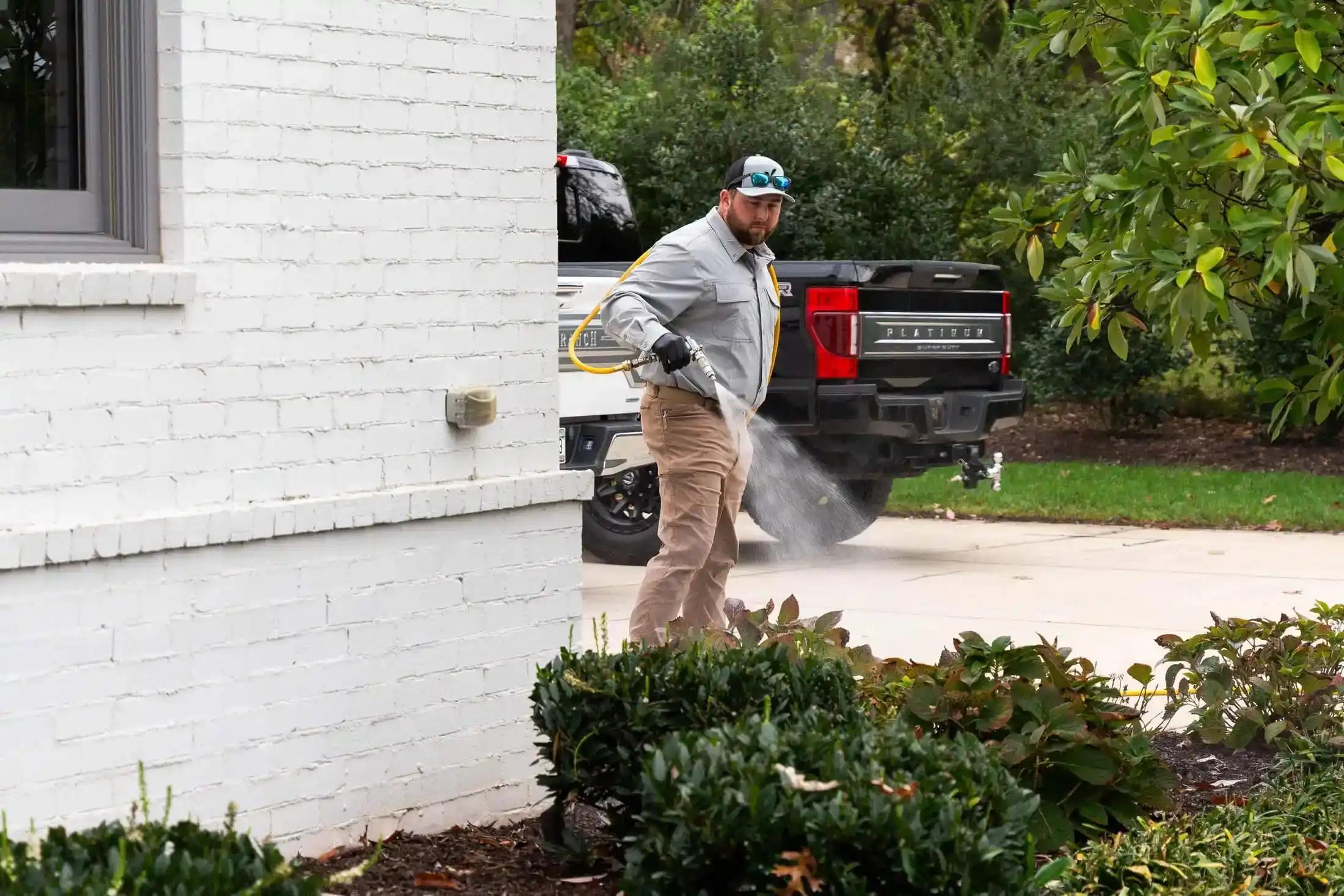 Veragreen technician providing on-site residential landscape maintenance services with service vehicle