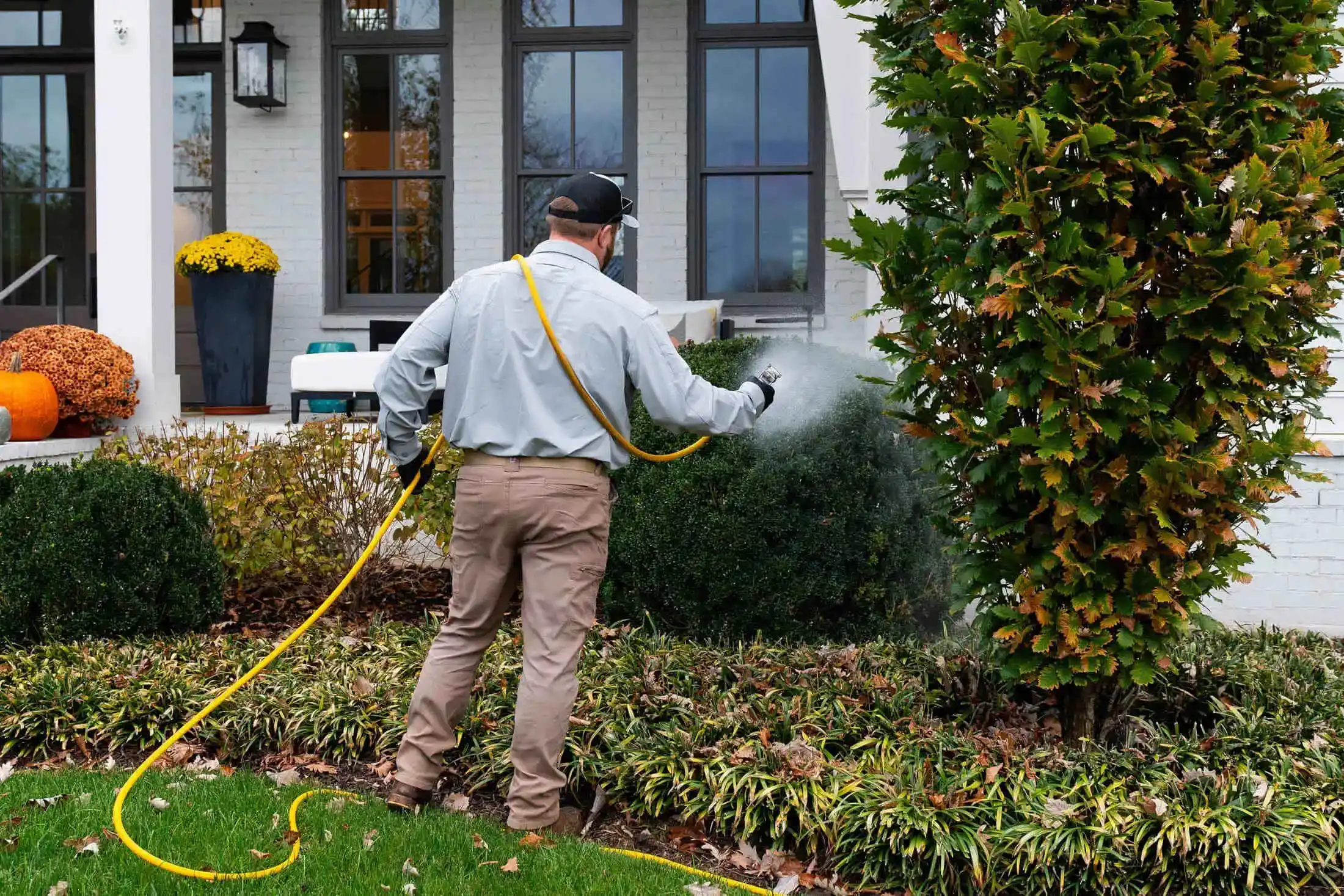Veragreen technician applying professional treatments at commercial property with extensive landscaping