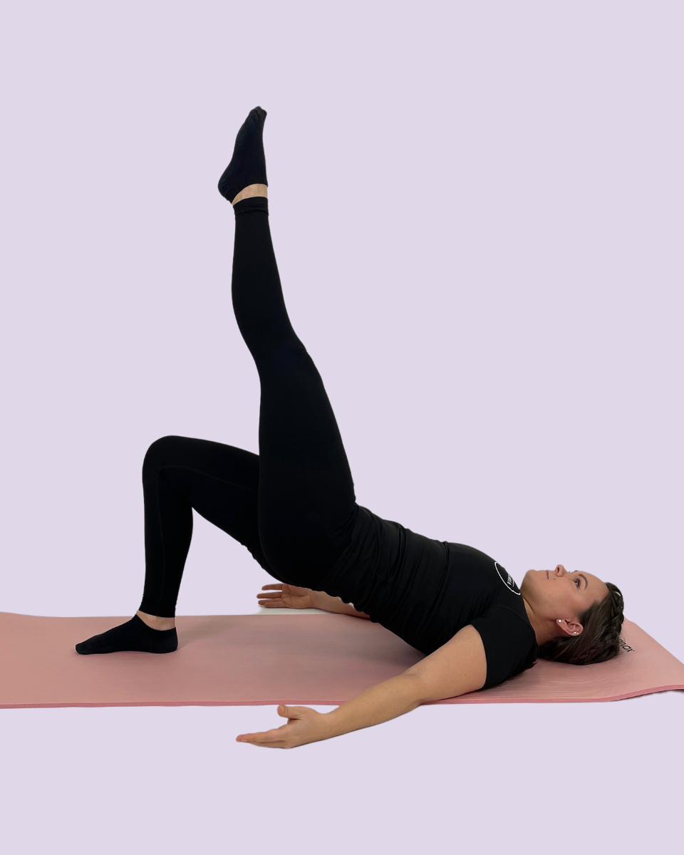 Pilatesohjaaja näyttää liikkeen.