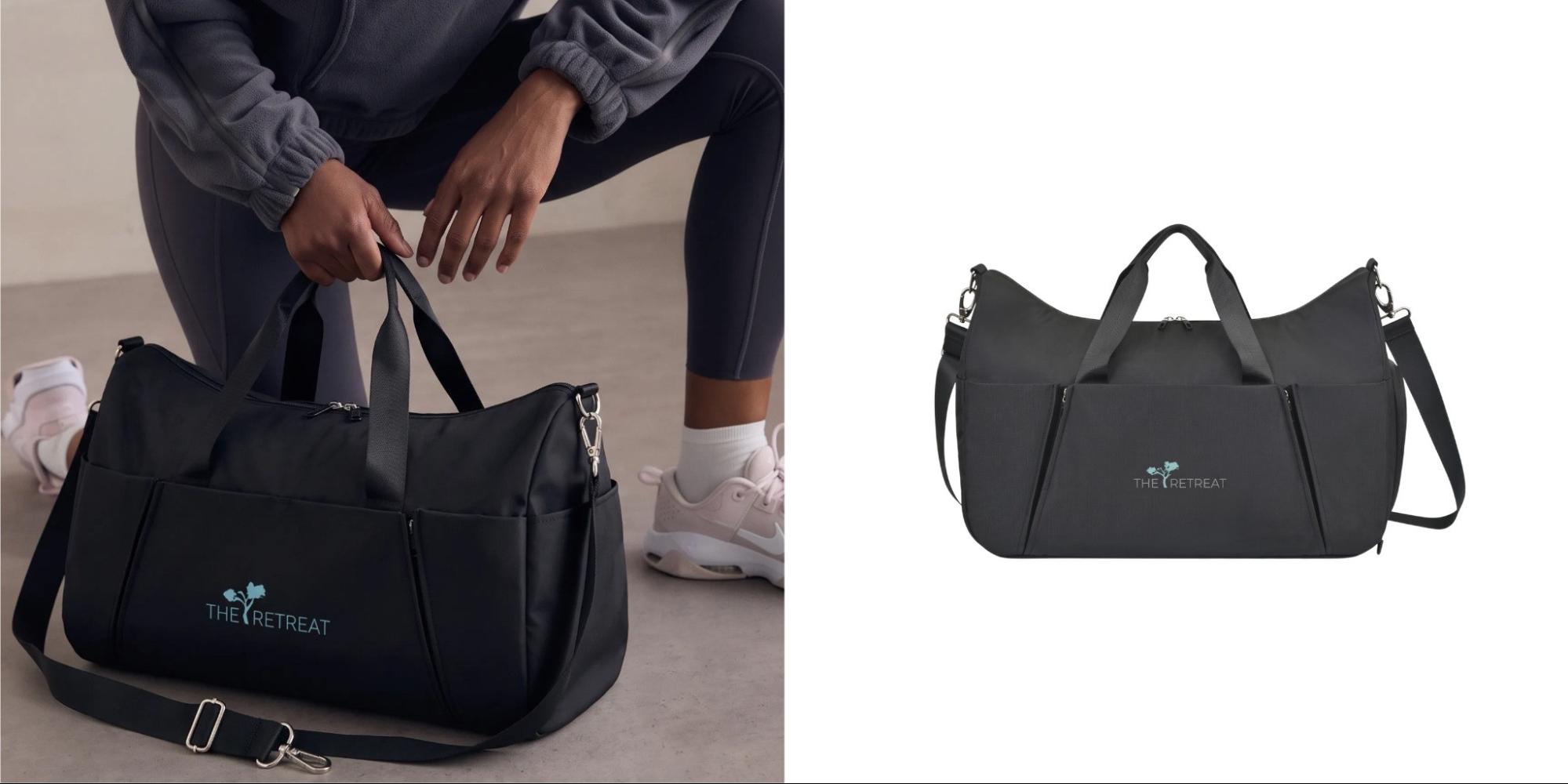 Person holding a black Well Studio recycled nylon duffel customized with The Retreat logo beside the product