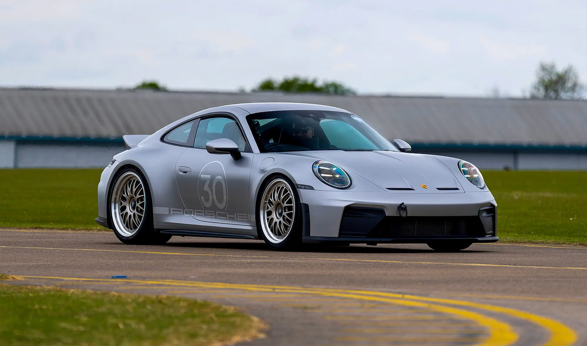 Porsche 992 GT3 Touring fitted with a Dissident carbon fibre fixed ducktail on track