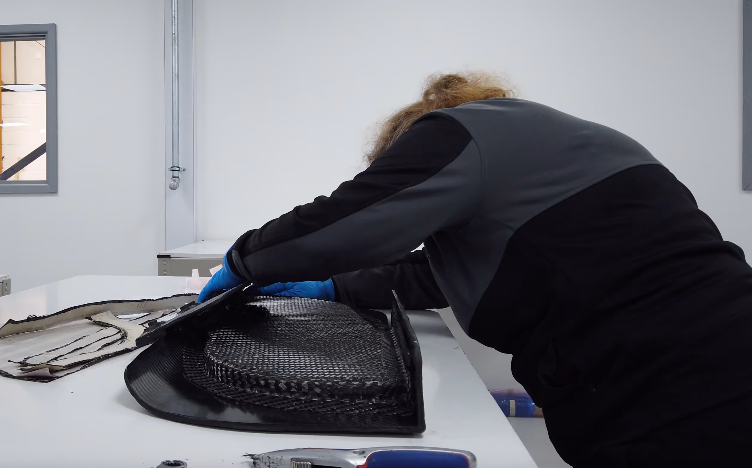 Carbon fibre cloth being laid into a mould by hand at the Dissident workshop