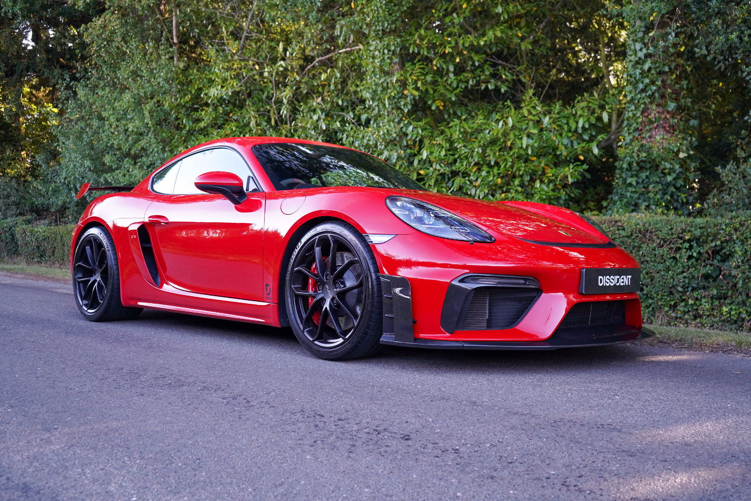 Porsche 718 GT4 fitted with a Dissident carbon fibre front splitter and aero curtains