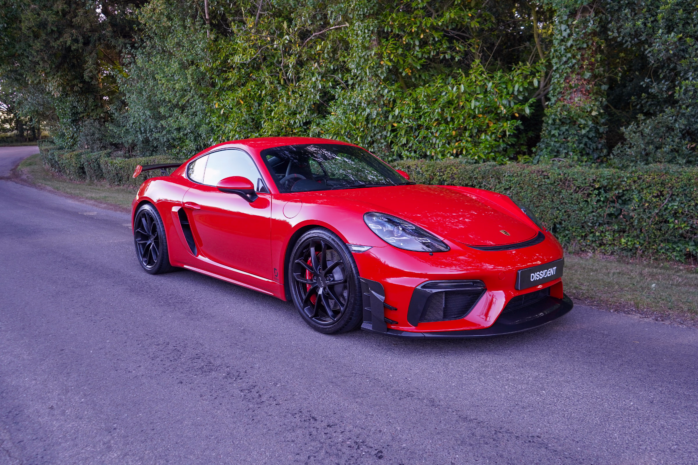 Porsche 718 Cayman GT4 fitted with a Dissident carbon fibre front splitter and track spec aero curtains