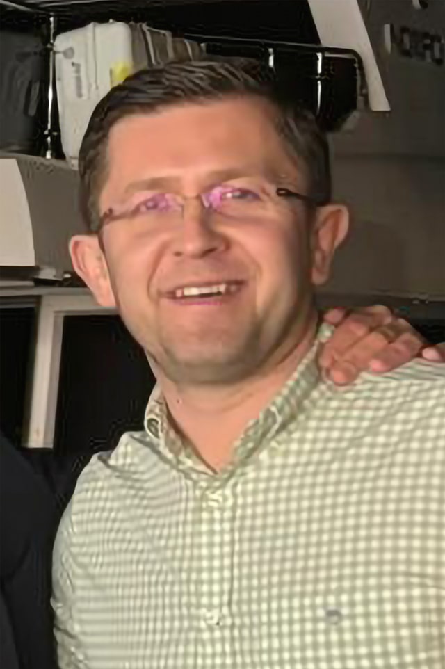 Andrew smiling at the camera