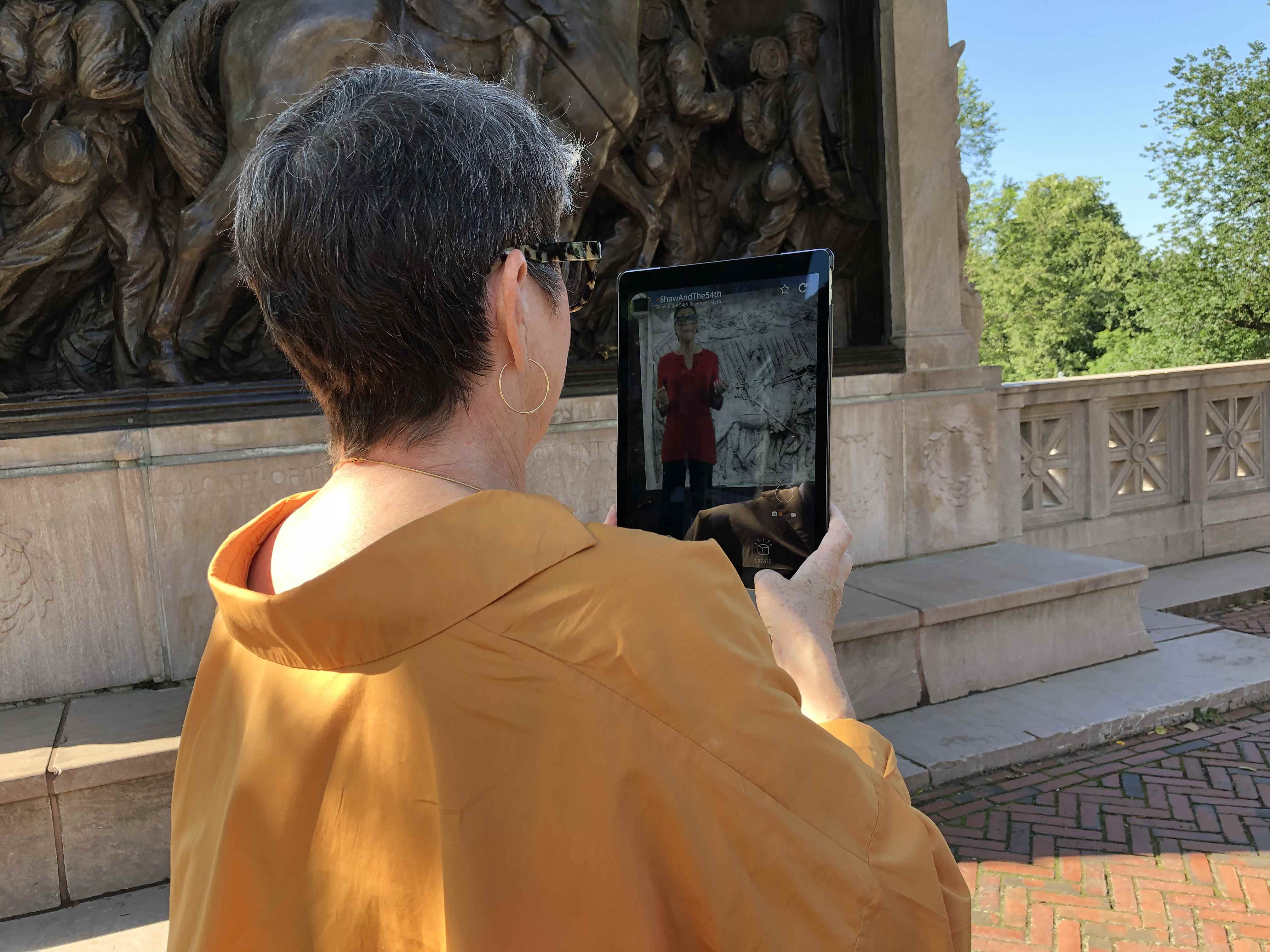 person using hoverlay app to view ar exhibit at boston commons