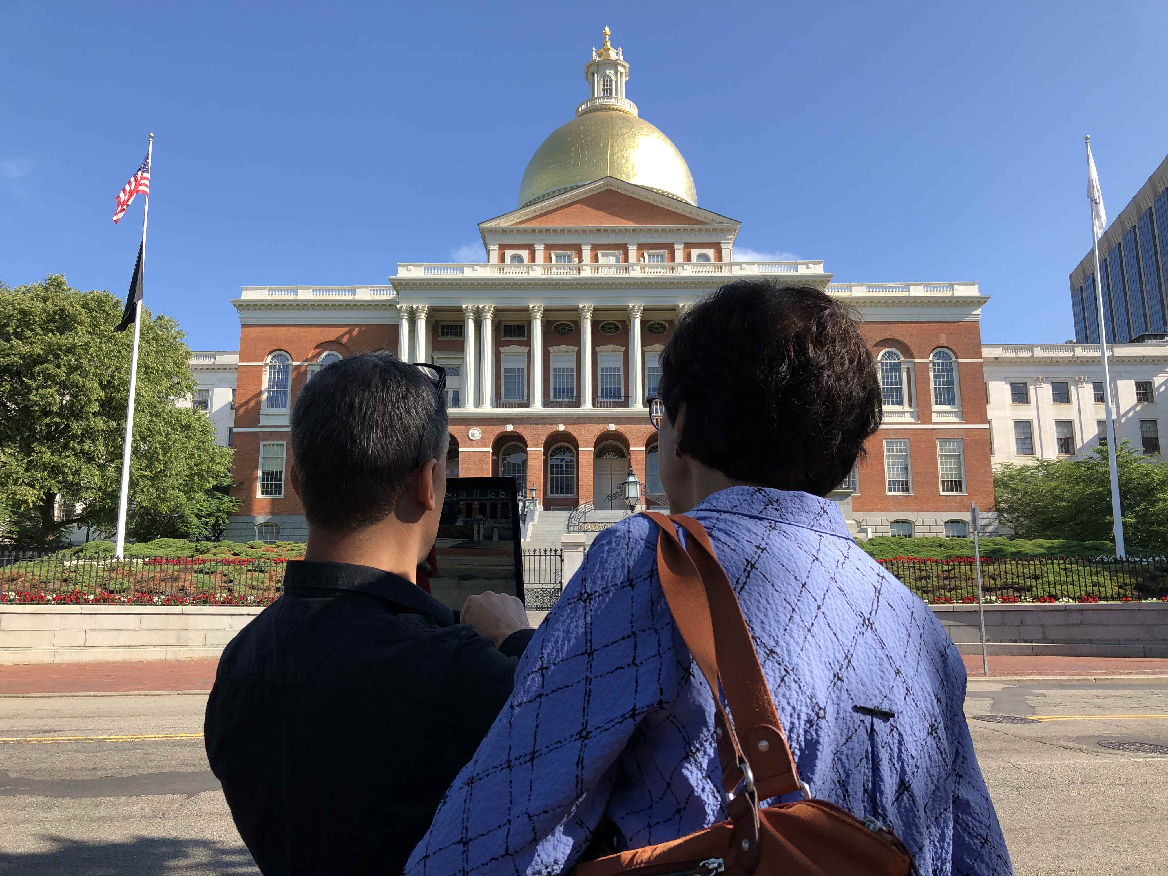 Users inspecting hoverlay ar  exhibit at boston commons